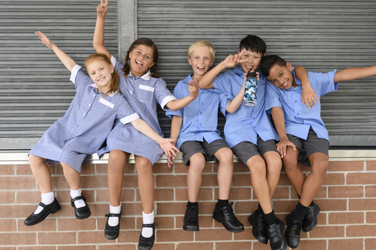 A group of multicultural children strike a silly pose.