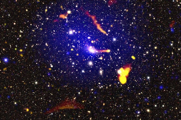 Colour-composite image of the merging galaxy cluster Abell 3266, using data from ASKAP and the ATCA (yellow, orange, and red colours), XMM-Newton (blue colours) and the Dark Energy Survey (background map).