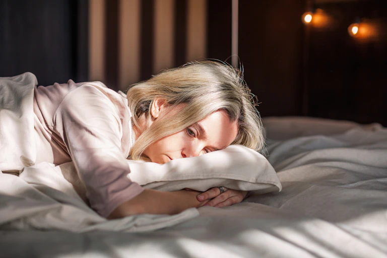 A woman lying on a bed.