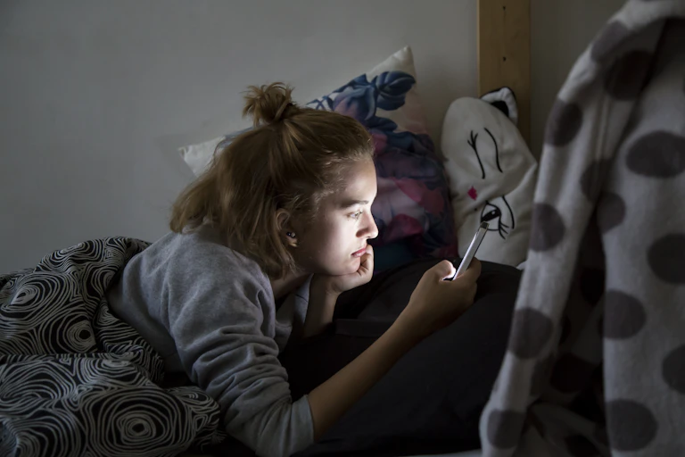Young girl looking at her phone