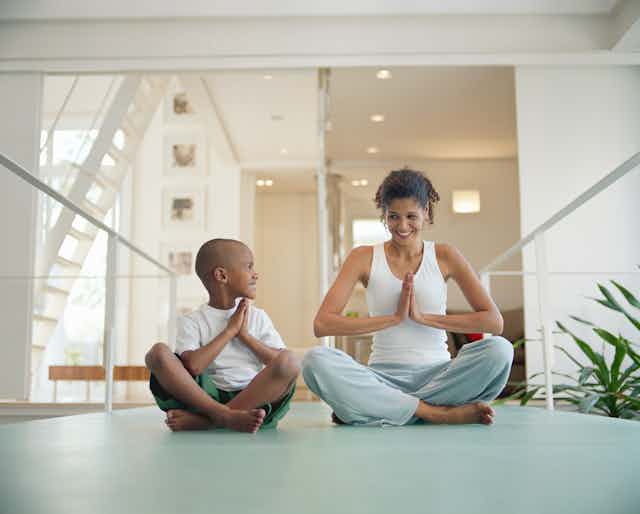 A mother and son practicing yoga together