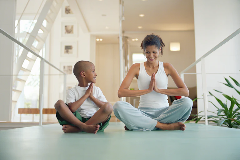 A mother and son practicing yoga together