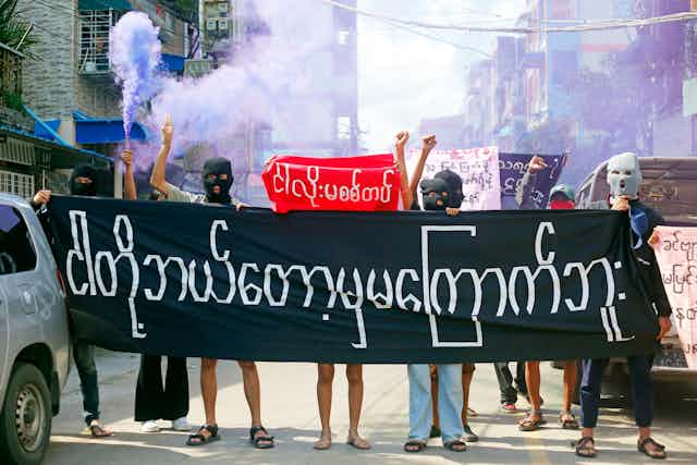Masked protesters in Yangon