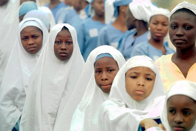 Girls dressed in Hijab head covering.