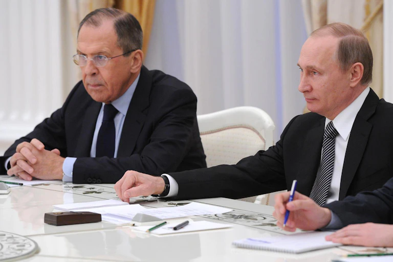 Two seated men wearing suits