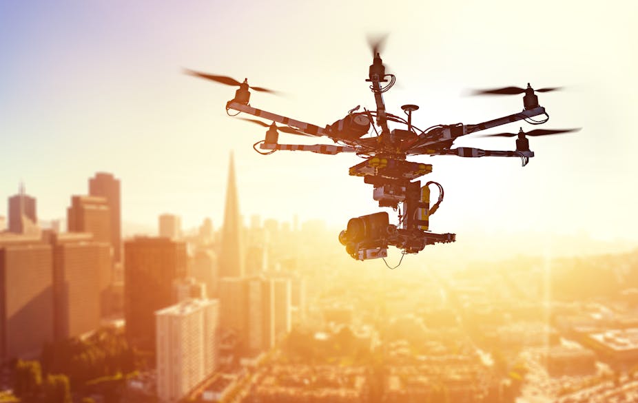 A drone hovers above a cityscape