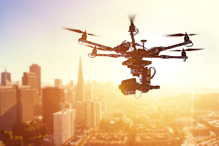 A drone hovers above a cityscape