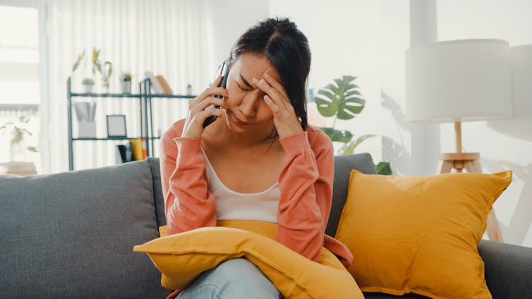 men looks tired on phone at home