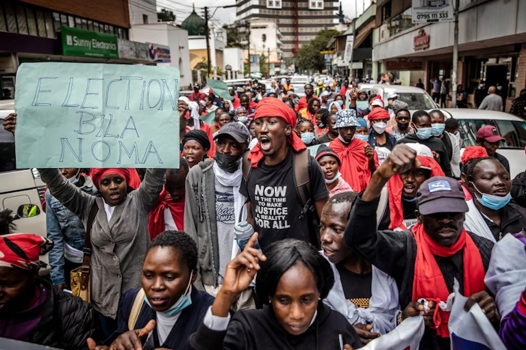 Men and women walking on the streets holding slogans calling for peaceful elections.