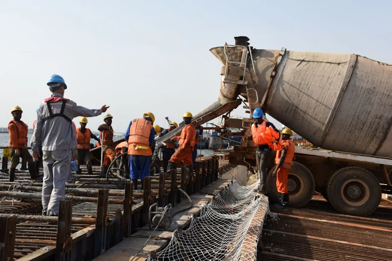 Men working at a port construction site.