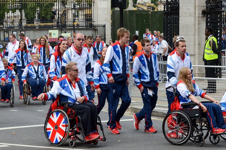 Athletes in uniform in a street setting.