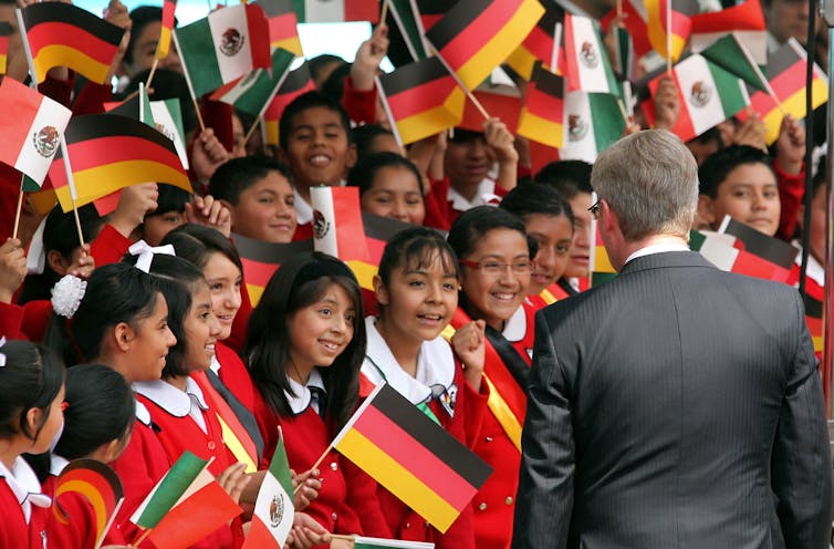 German President Christian Wulff greets flag-waving Mexican schoolchildren in Mexico City, 2011.