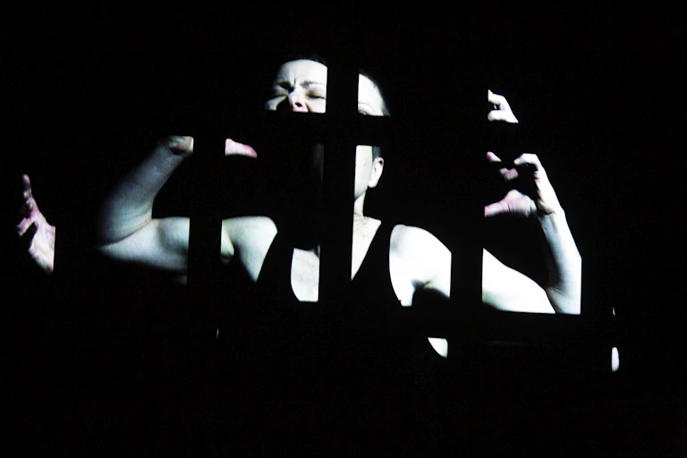 A fractured woman screams, or sings