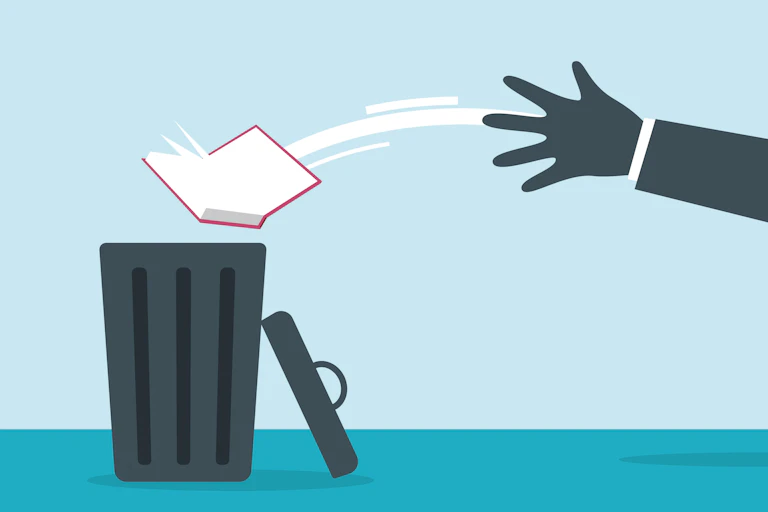 Picture of a hand throwing a book in a trash can