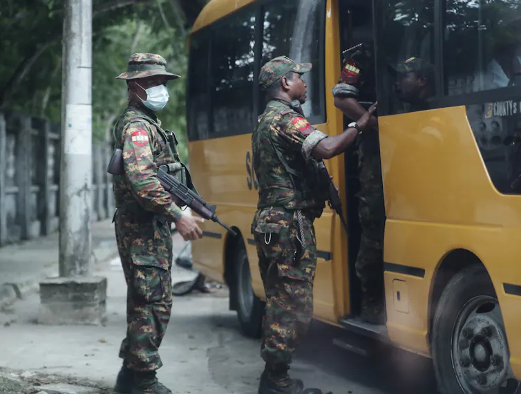 Soldiers board a school bus