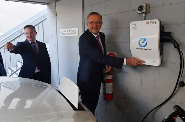 Chris Bowen and Anthony Albanese beside an electric vehicle