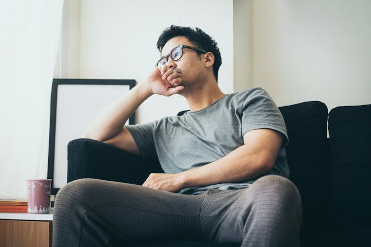 A young man sitting on a couch.