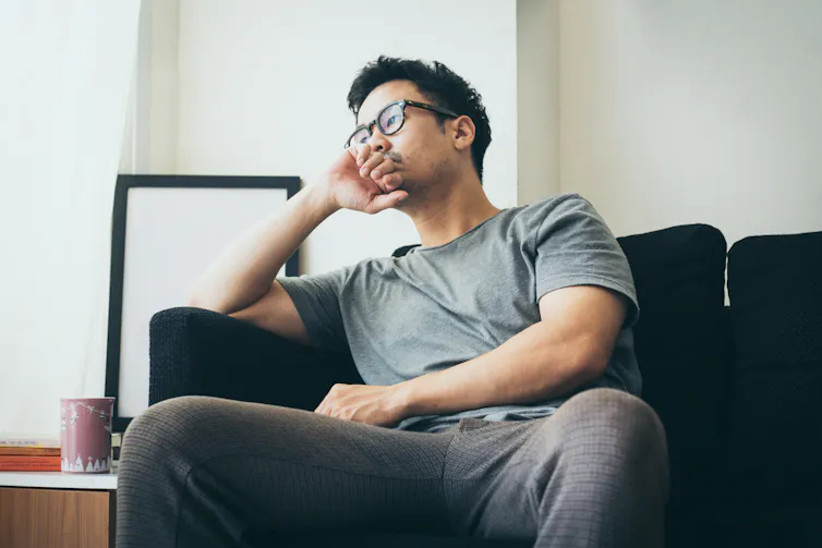 A young man sitting on a couch.