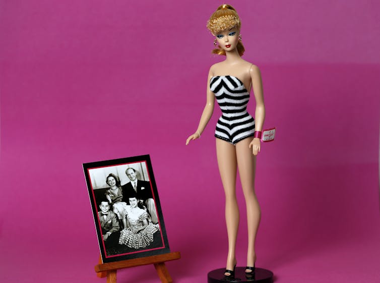 Barbie doll in black and white stripped swimsuit.