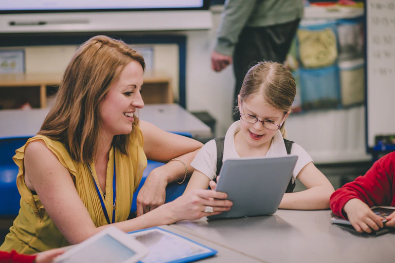 Teaching assistant works with student.