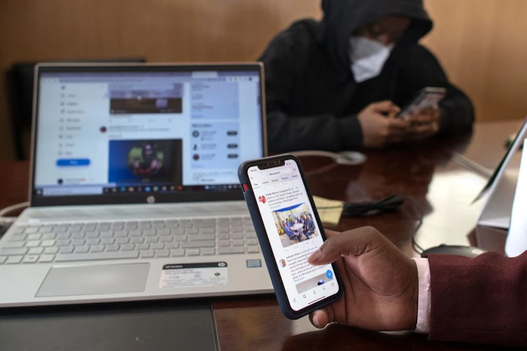 Browsing social media platforms on mobile phones.