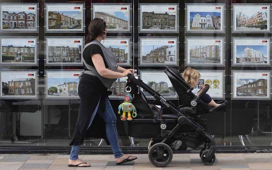 A woman looks at adverts in an estate agent window in south-west London, Britain, 22 August 2016 