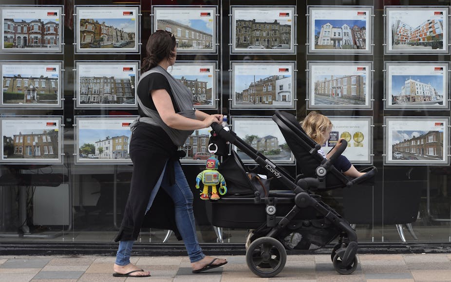 A woman looks at adverts in an estate agent window in south-west London, Britain, 22 August 2016