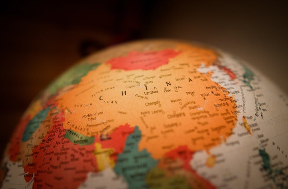 A world globe with China at the center of the map.