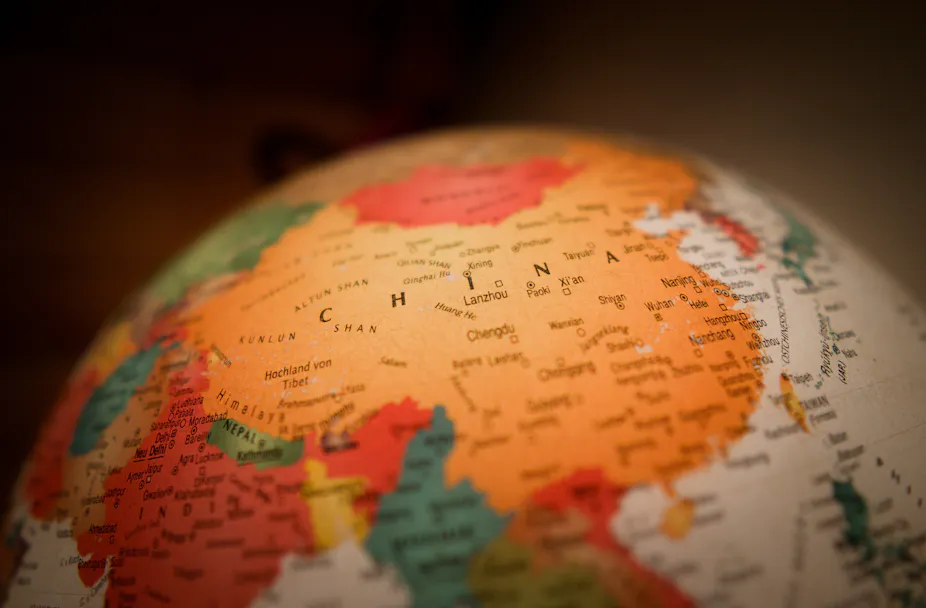 A world globe with China at the center of the map.
