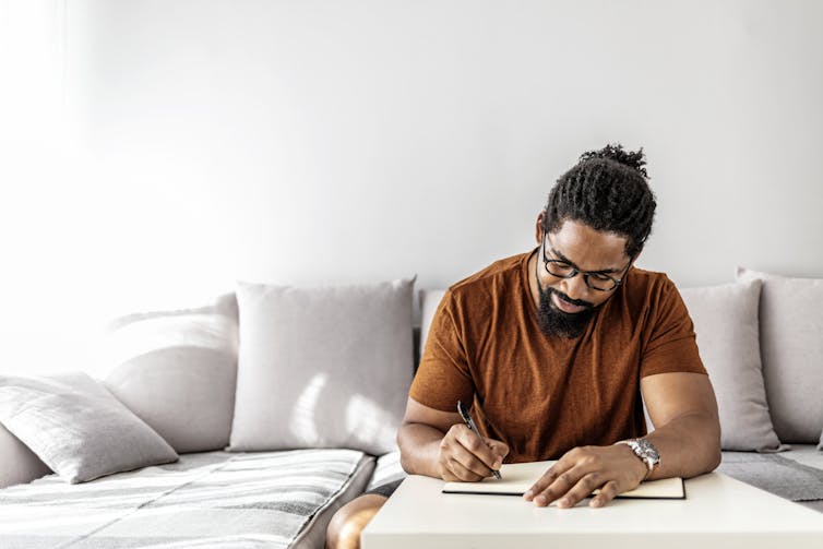 Man writing in journal