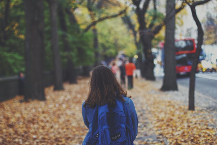 girl walks outside near trees