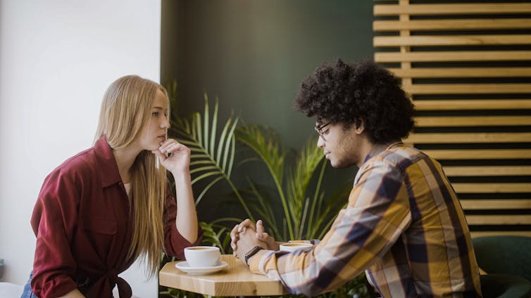 two people talking at a table