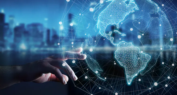 Global hologram with blurred cityscape background.