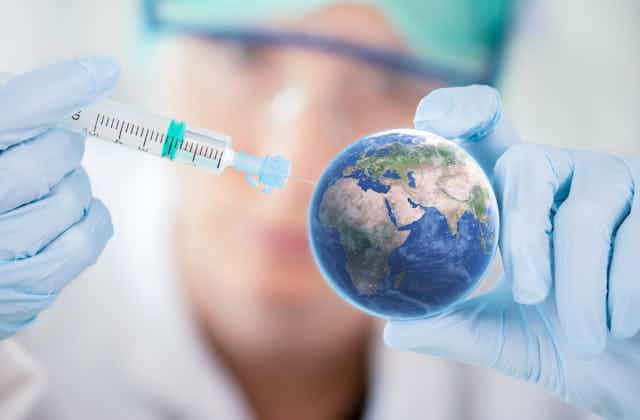 Syringe injecting model of Earth.