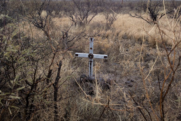 White cross in scrubby terrain