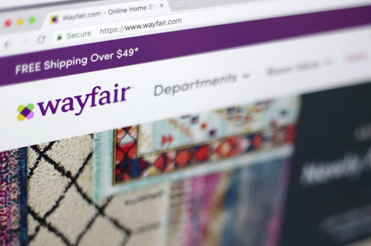 The Wayfair website with its purple logo is seen on a computer screen.