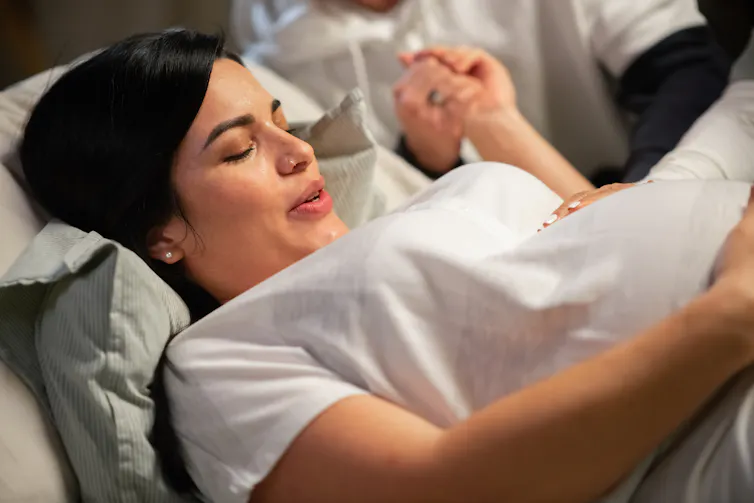 Woman in labour breathes heavily