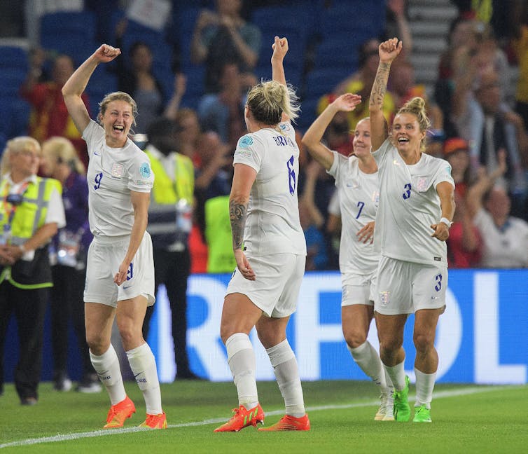 Footballers celebrate.