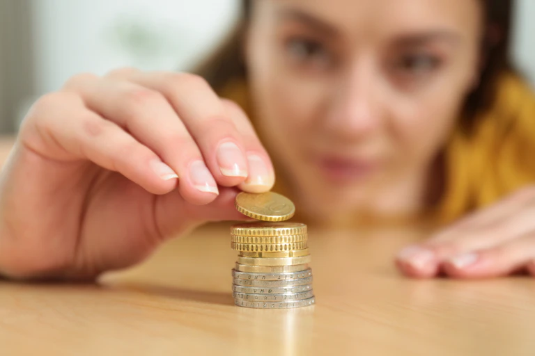 Woman stacking coins