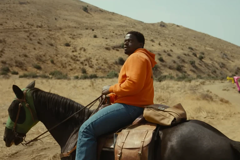 A screenshot from the movie 'Nope' of the character OJ Haywood sitting on a horse