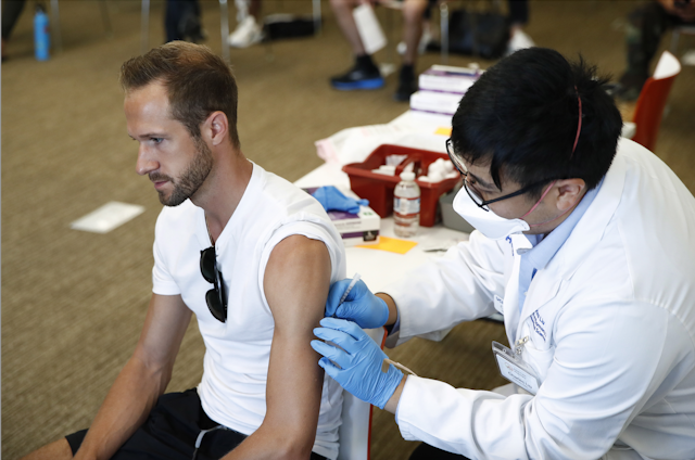 Man receiving monkeypox vaccine un summer arm