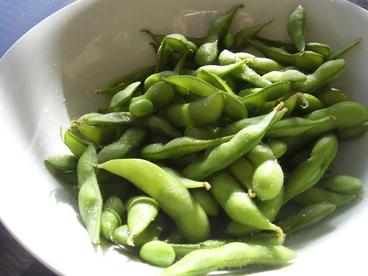 Edamame beans sit in a bowl.
