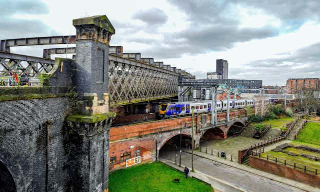 A Victorian railway bridge passed over a another bridge and a street below.