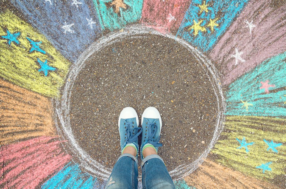 Person stands in brightly coloured chalk circle