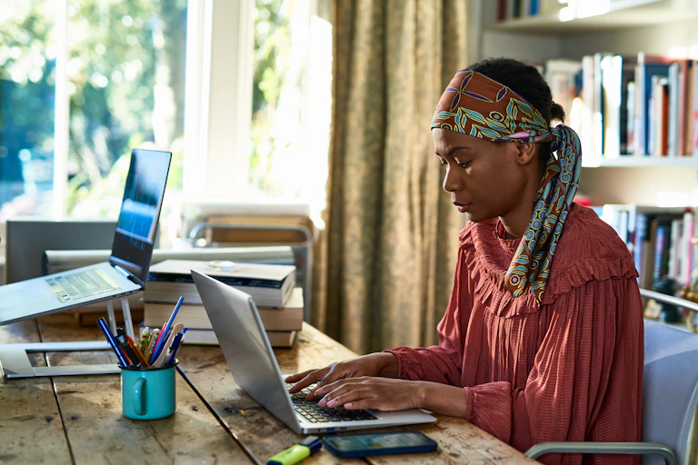 Woman working on a laptop computer at a desk