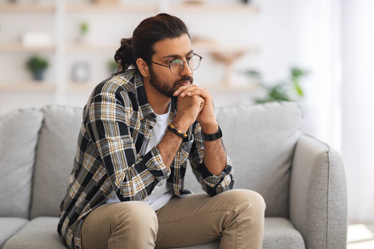 A young man sitting on a couch.