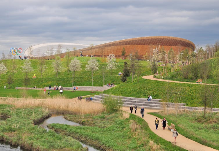 Landscaped green spaces with a large brown structure in the background.