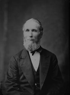 Black and white photo of a bearded man in a suit