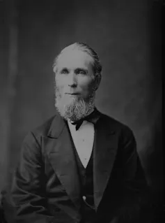 Black and white photo of a bearded man in a suit