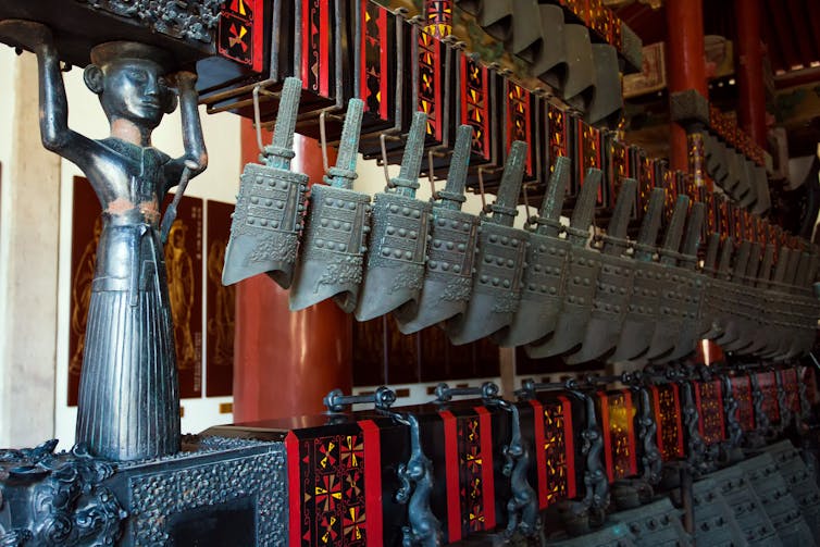 A set of bronze bells on display.